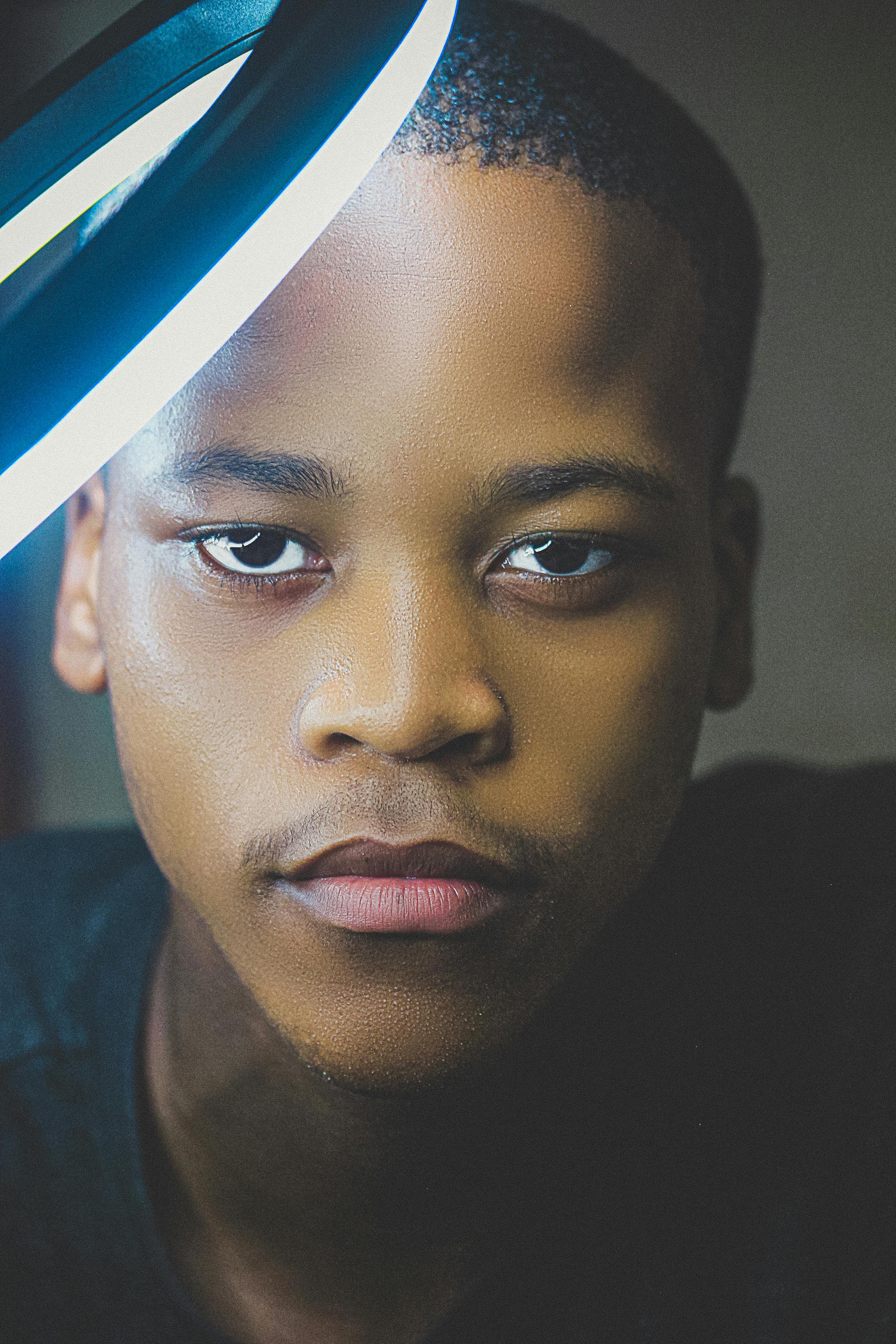 A detailed close-up portrait of a teenage boy with focused expression.