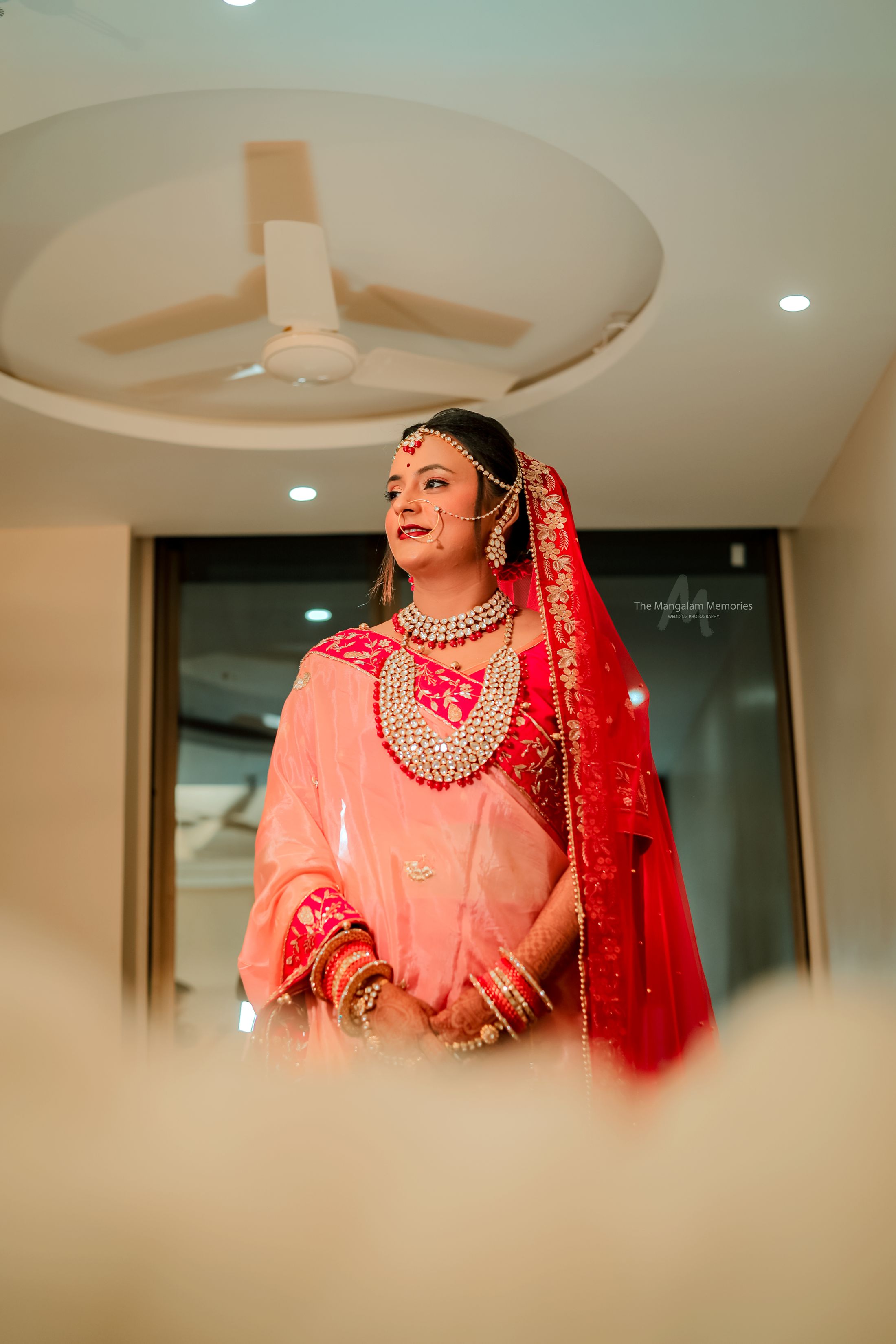 Indian bride in a red bridal lehenga and traditional jewellery