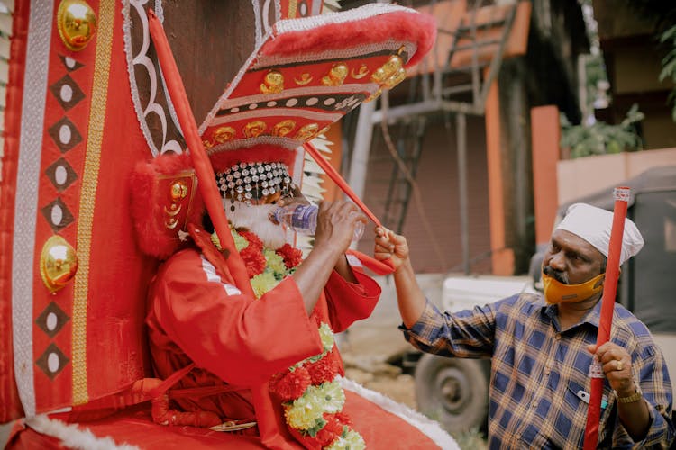 Man In A Costume On A Carriage At A Parade 