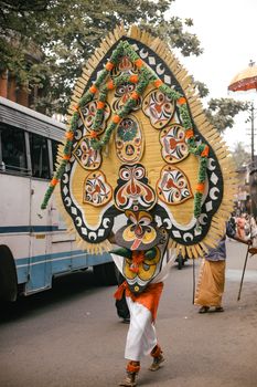 A vibrant display of traditional costumes in a lively street festival parade.