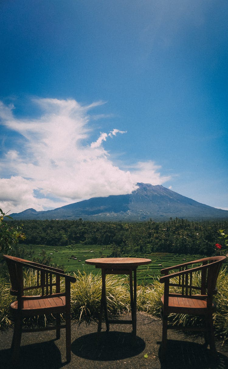 Table And Chairs With Mountain And Cloud Behind