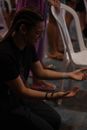 A Woman in Black Shirt Kneeling in Worship