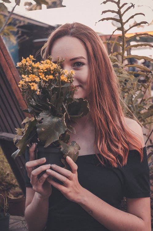 Woman Holding a Pot of Flower