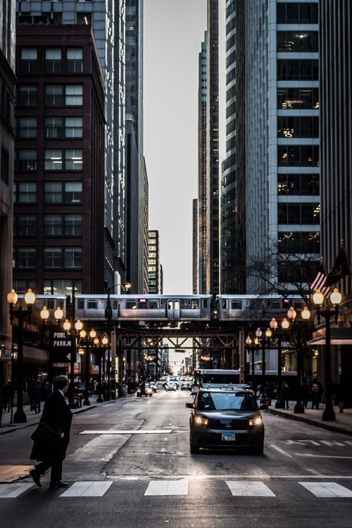 Free Dramatic Chicago cityscape with urban street and elevated train in daylight. Stock Photo