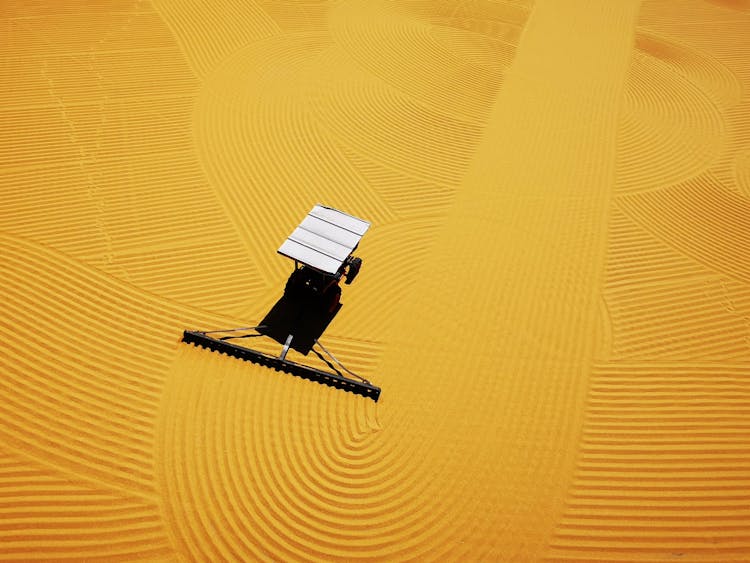 A Vehicle Raking A Pattern In Sand