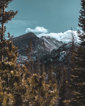 Breathtaking view of snow-covered Rockies and forests in CO, USA.