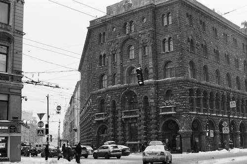 Monochrome Shot of Cars near a Concrete Building 