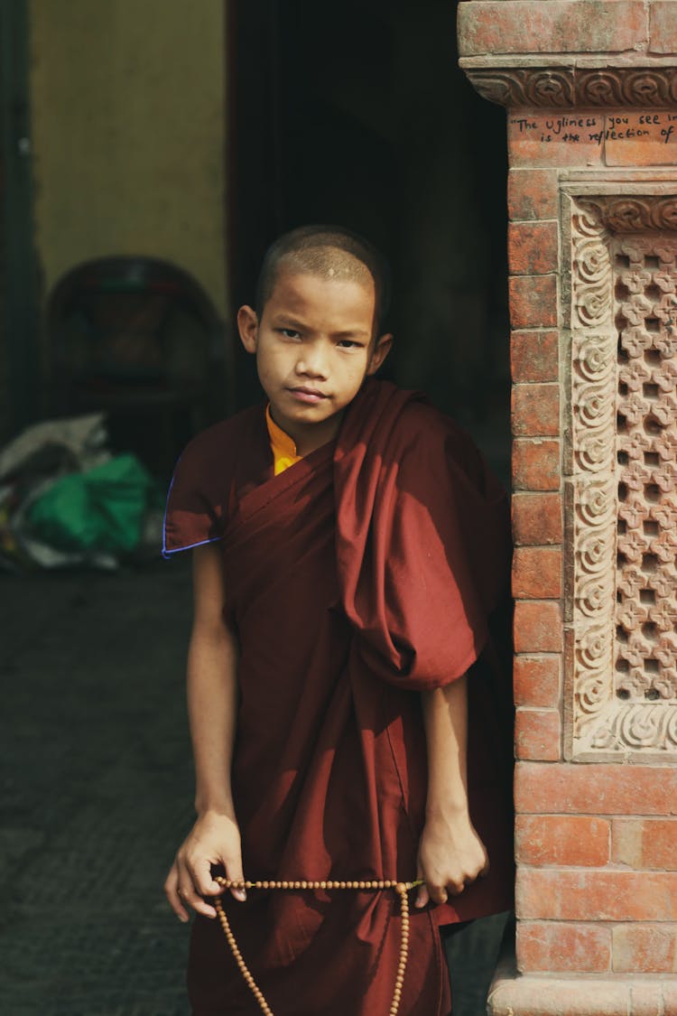 Boy Posing In Monk Robes