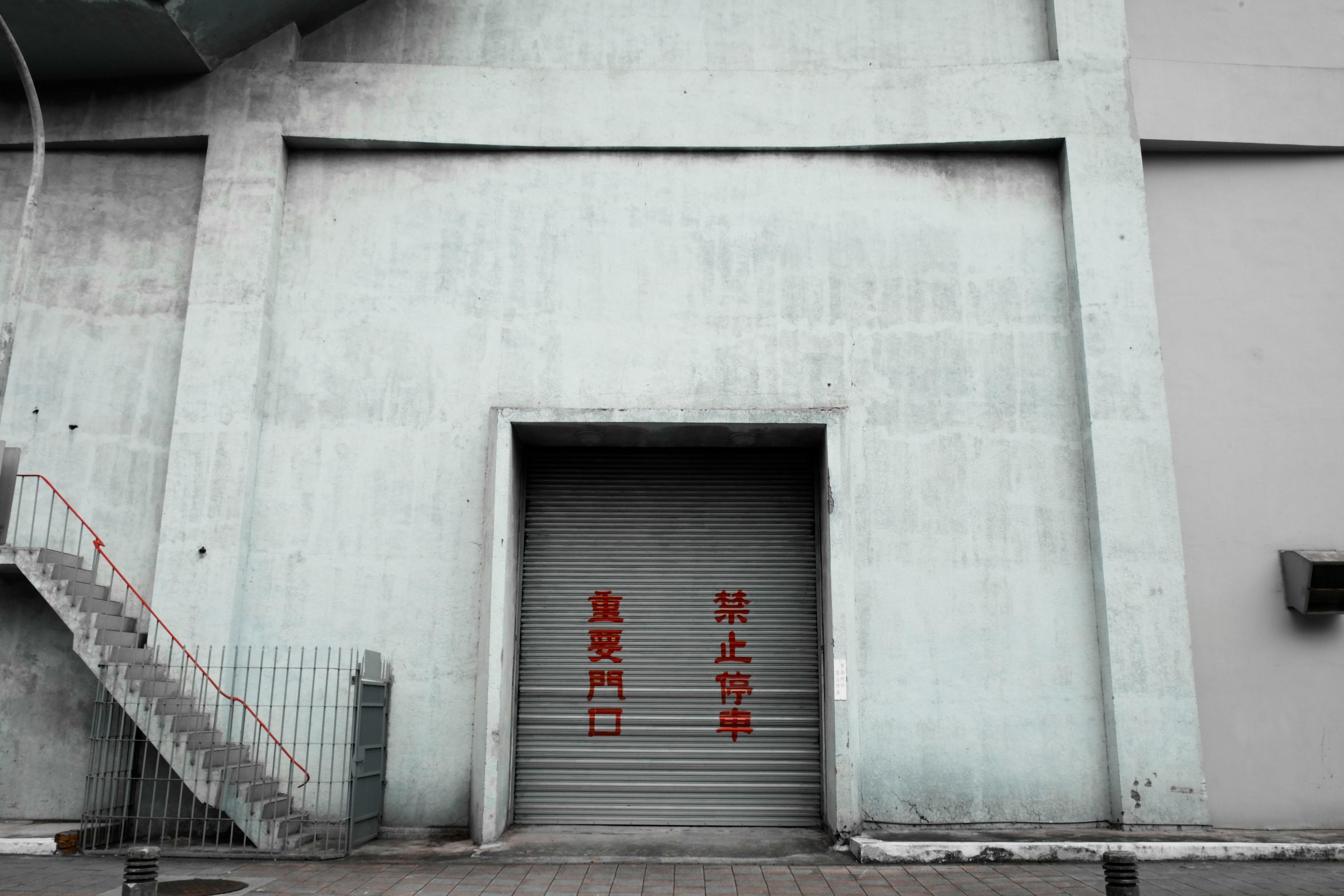 Exterior view of an industrial concrete wall and steel staircase in Taipei, Taiwan.
