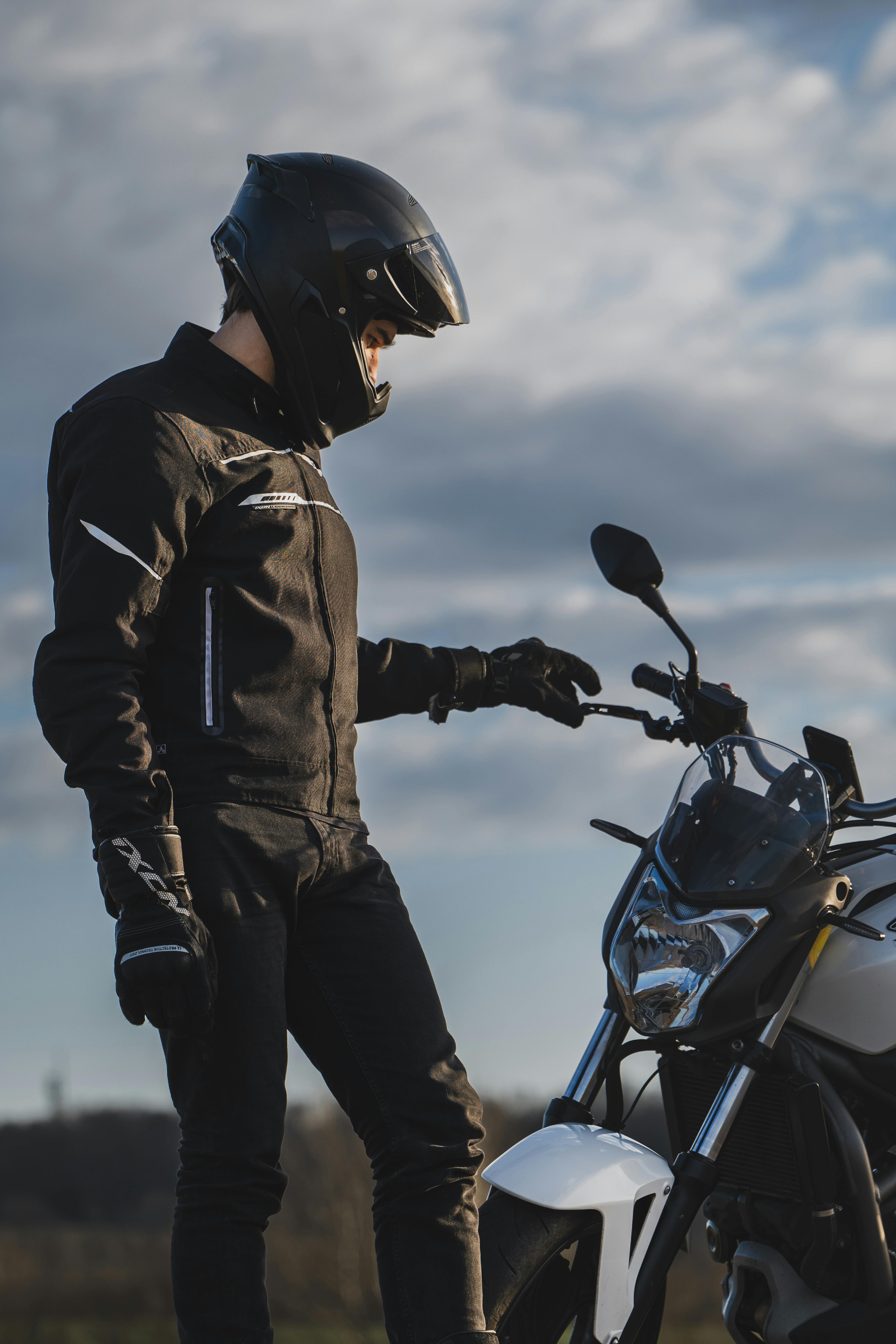 Man in Black Jacket and Black Pants Standing Near the Motorcycle · Free  Stock Photo