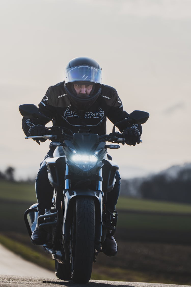 Man Riding Motorcycle With Black Helmet