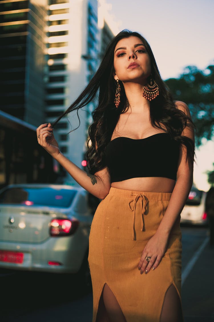 Woman Wearing Black Crop Top And Orange Skirt Standing