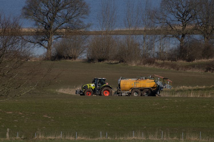 Claas Tractor On Meadow Delivering Manure And Got Stuck