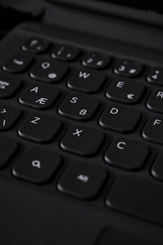 Detailed close-up shot of a black computer keyboard with special character keys.