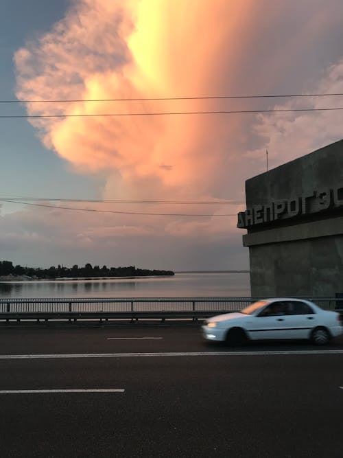 A White Car Travelling Beside the Sea