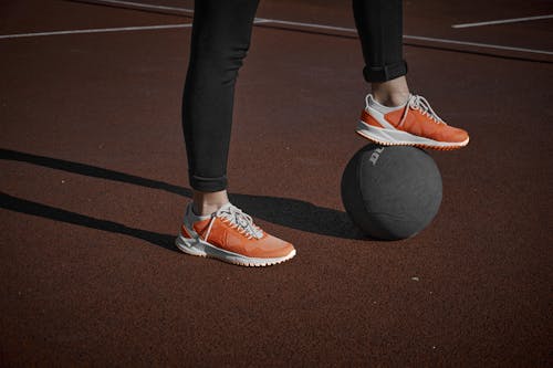Free A Person Stepping on the Ball Stock Photo