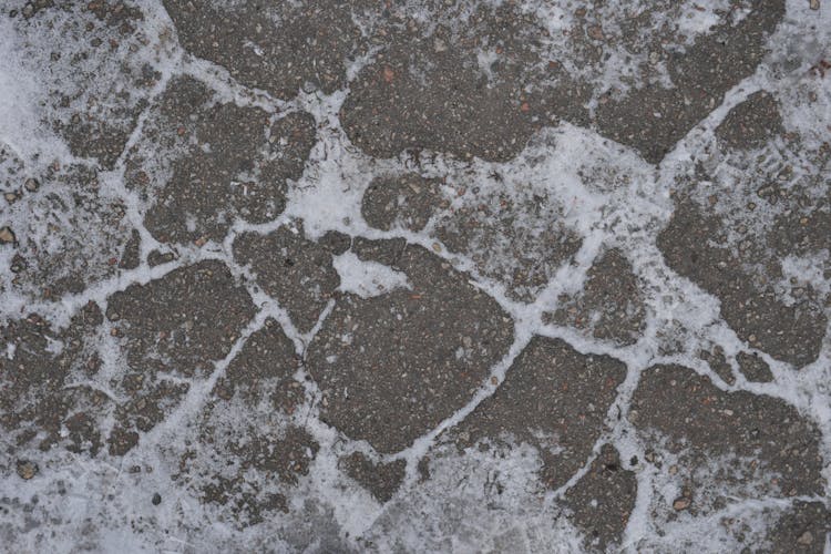 A Snow Covered Cobblestone Floor During Winter