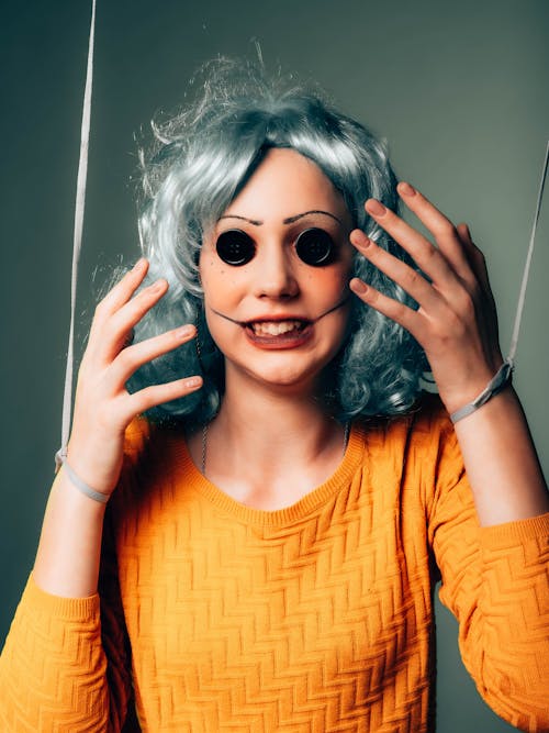 Portrait of Woman Dressed Like a Puppet in a Gray Wig With Button Eyes