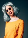 Woman in Orange Crew Neck Shirt Wearing Black Sunglasses
