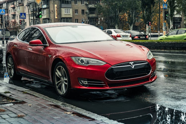 Red Tesla Car On The Roadside