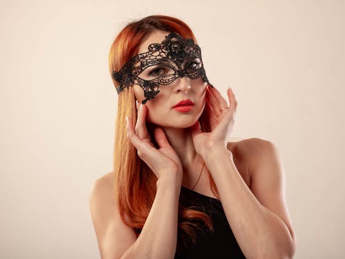 Close-Up Shot of a Woman Wearing a Masquerade Mask