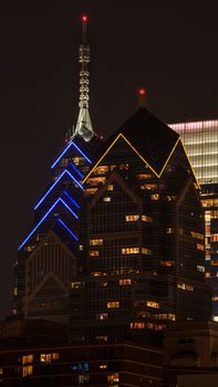 Illuminated skyscrapers in Philadelphia skyline at night, showcasing architectural beauty.