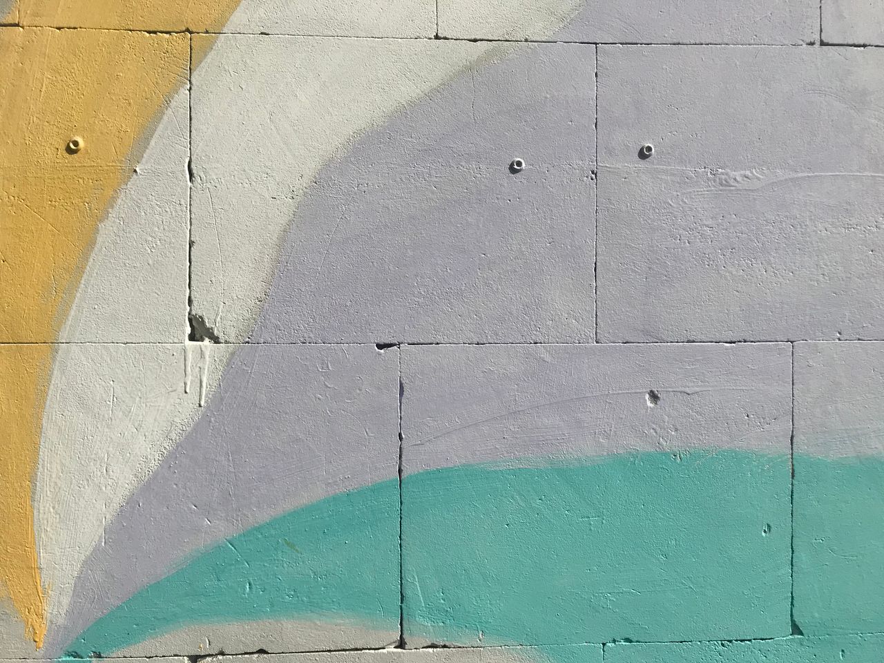 a colorful abstract mural with pastel shades painted on an urban wall