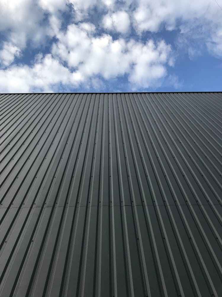 Gray Corrugated Metal Roof Under White Clouds