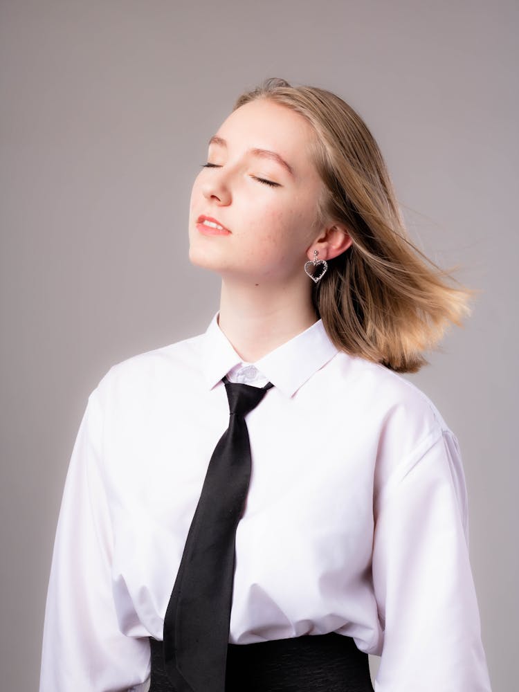 Young Girl In White Long Sleeve Shirt And Black Necktie