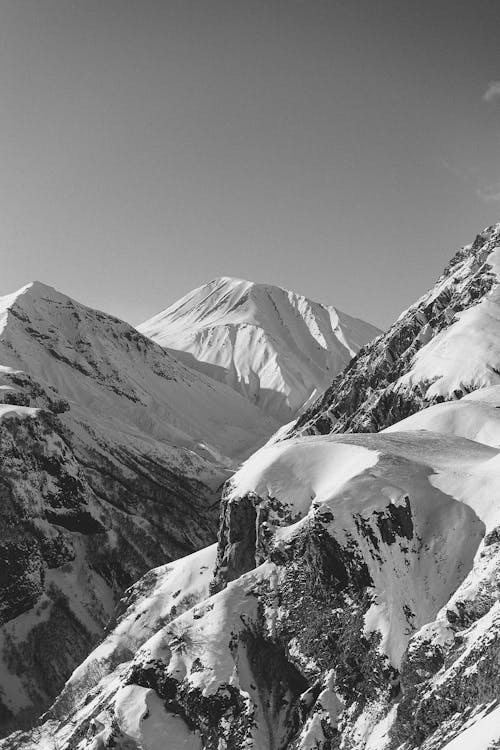 Grayscale Photo of Snow Covered Mountain