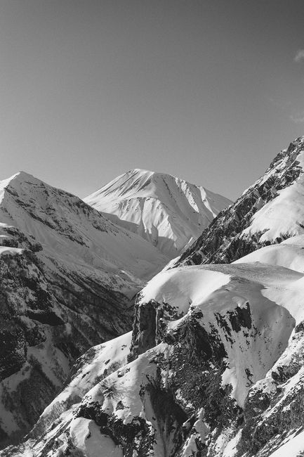 Dramatic black and white view of snowy mountain peaks in Gudauri, Georgia.