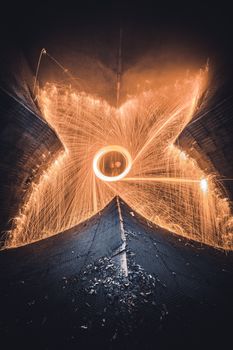 Dazzling long exposure of spinning light trails and steel wool sparks in a Moscow tunnel.