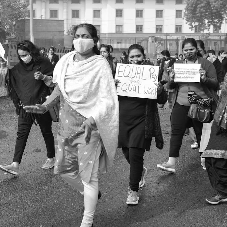 Women Wearing Face Masks Holding Placards Walking On The Street