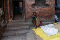 An Elderly Woman Holding a Winnowing Basket