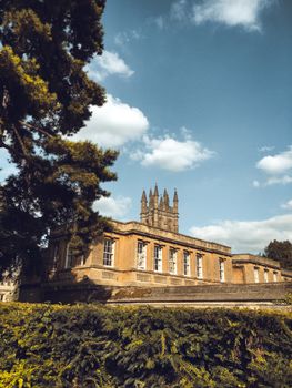 Beautiful historic Oxford architecture with lush greenery and blue skies.