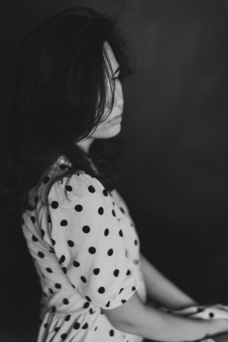 Side Portrait Of Woman In Dotted Dress