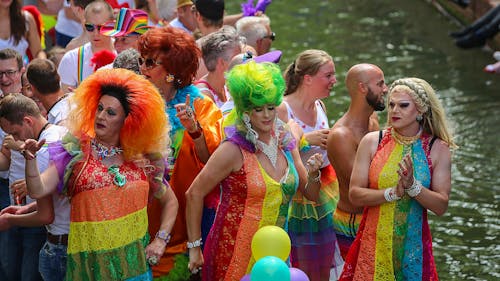 Free Three People Wearing Rainbow Dresses Dancing in Front of Crowd Stock Photo