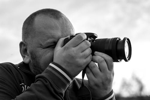 Free A Man Holding a Camera Stock Photo