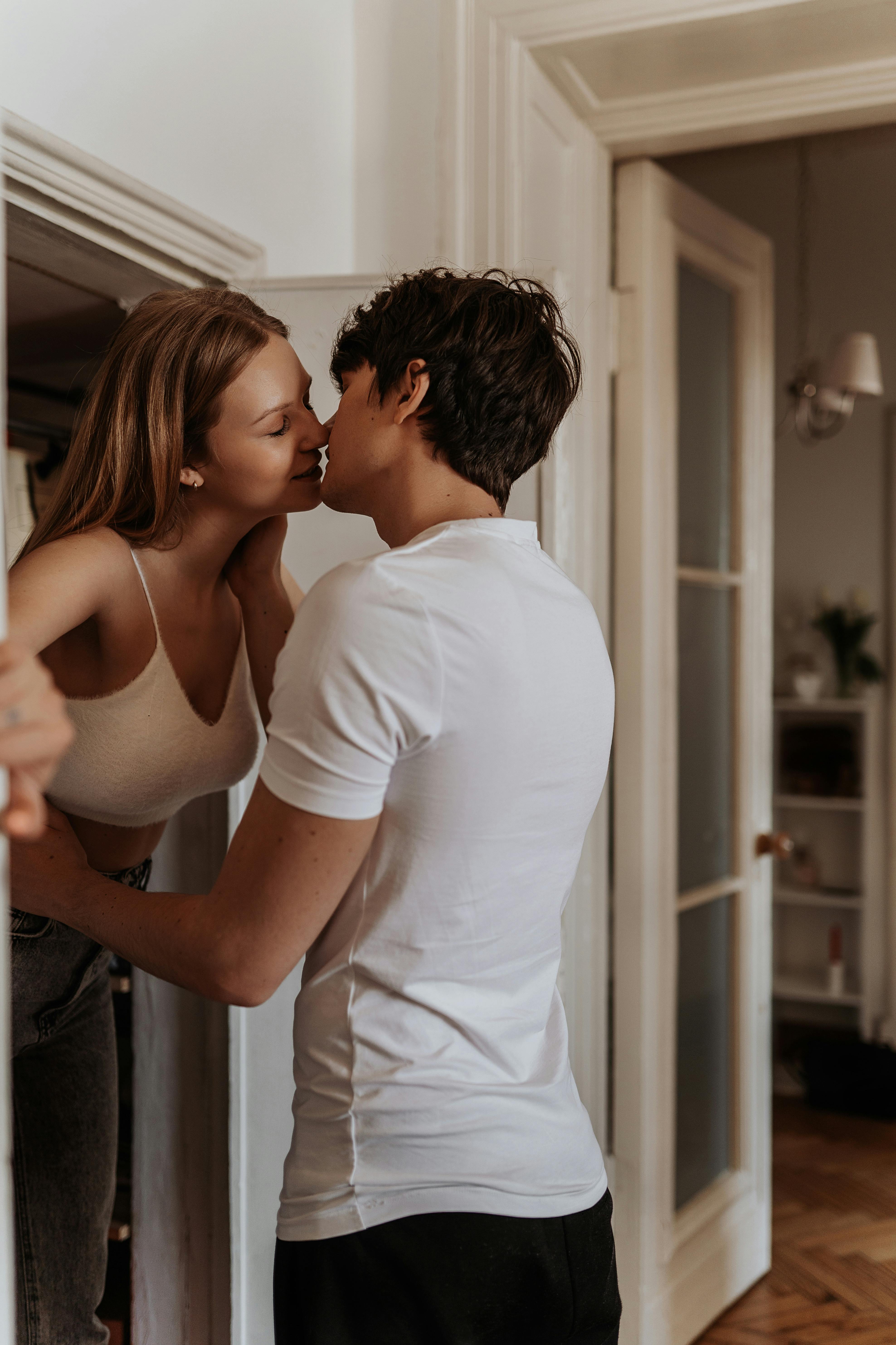 A loving couple shares an intimate moment in a warm indoor setting.