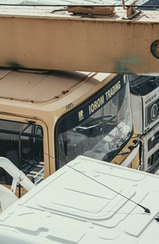 Close-up of industrial trucks in an abandoned motorpool, highlighting transport and industry themes.