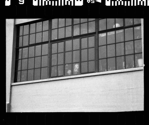 Free Black and white shot of a factory window capturing a serene indoor moment. Stock Photo