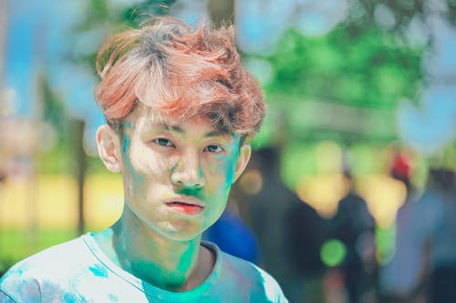 Man Covered in Green Powder in Shallow-focus Shot