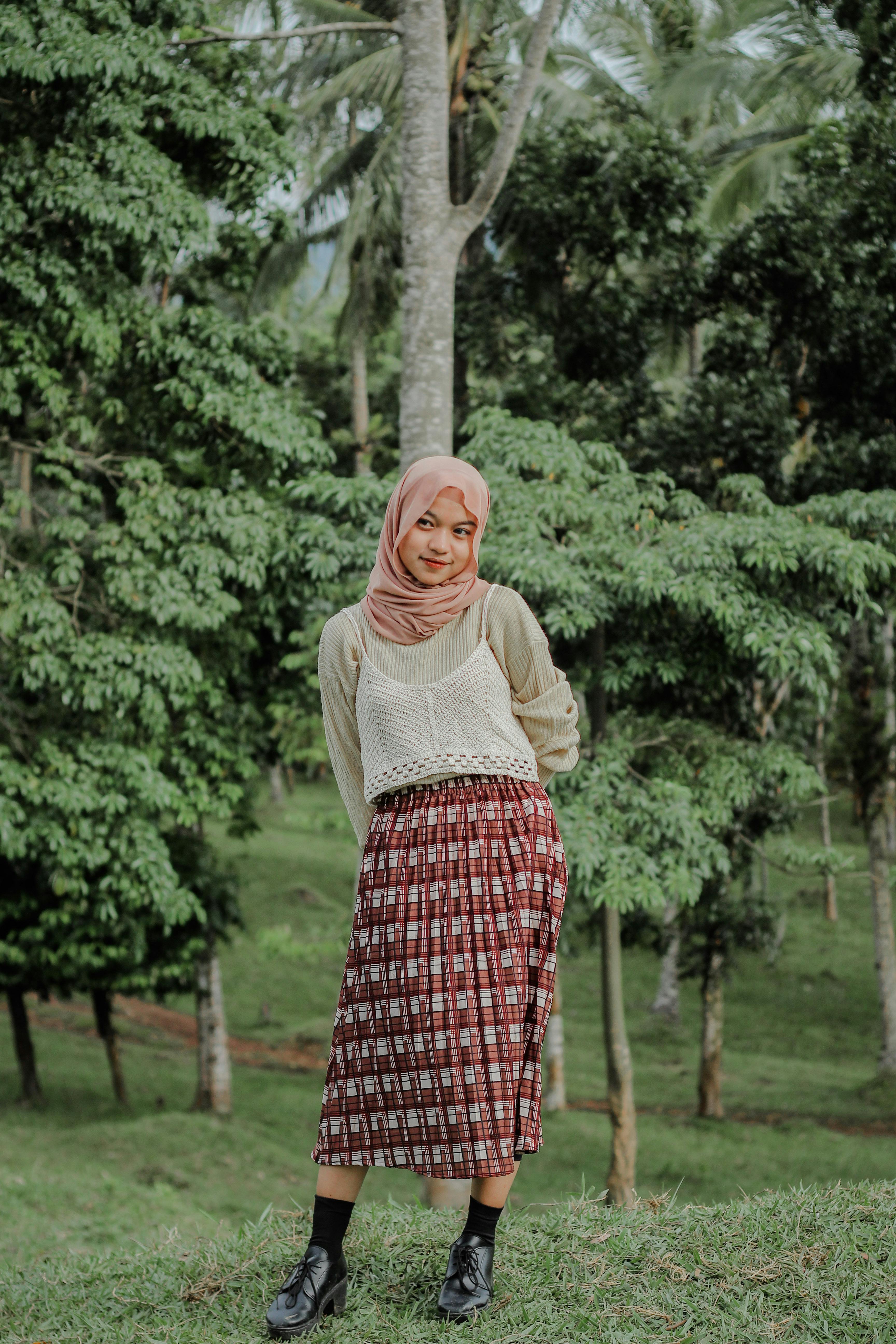 Portrait of a young woman smiling and posing in a tropical forest in Banten, Indonesia.