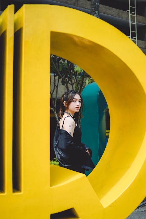 Woman behind Yellow Item