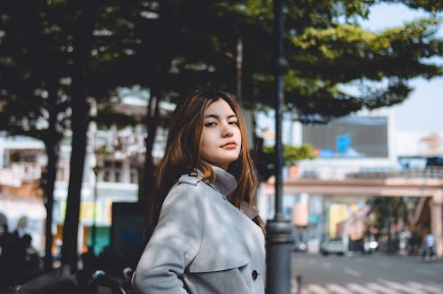 Woman in Gray Coat Standing Near Trees