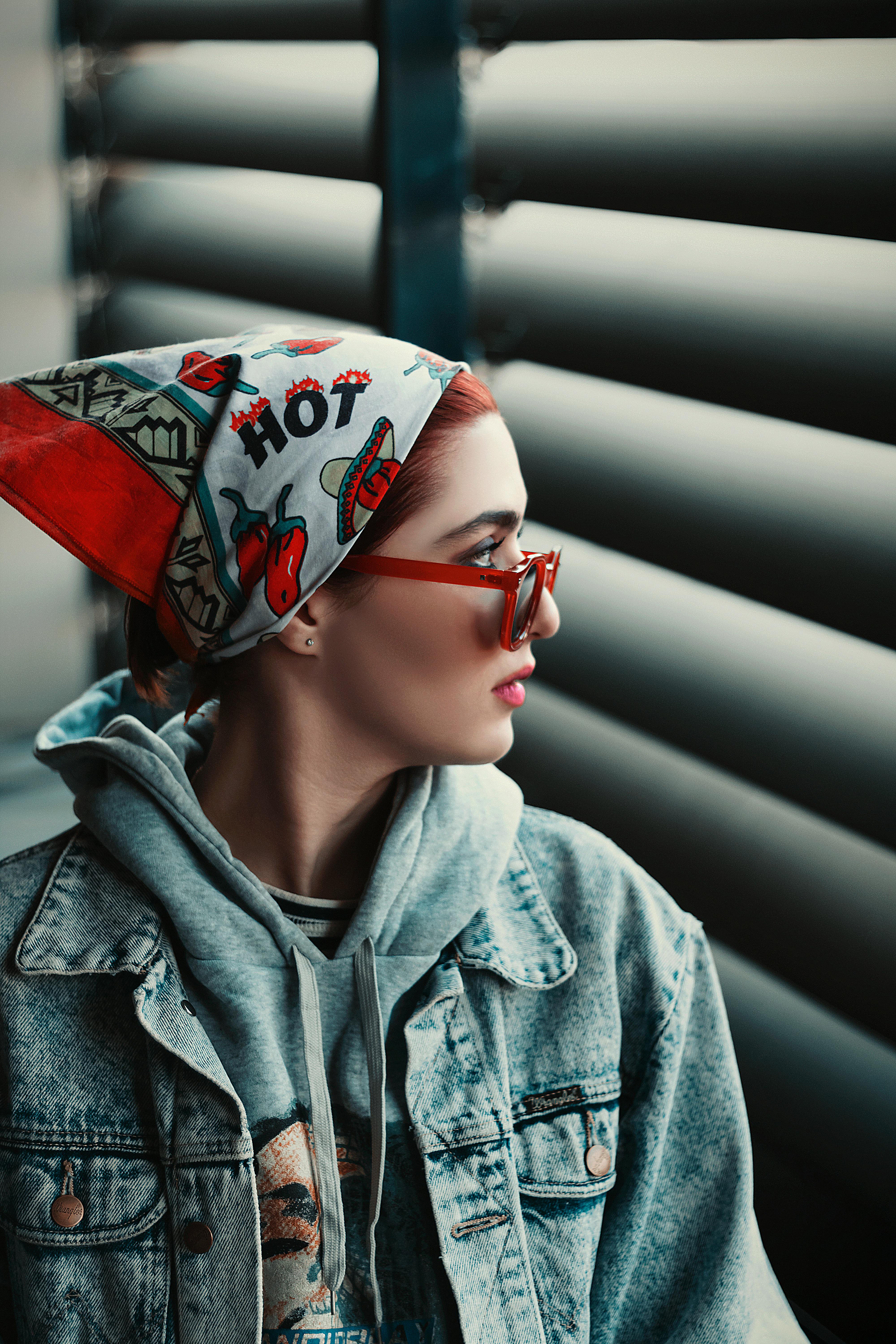 Portrait of a fashionable woman in Tehran wearing a colorful bandana, sunglasses, and denim jacket.