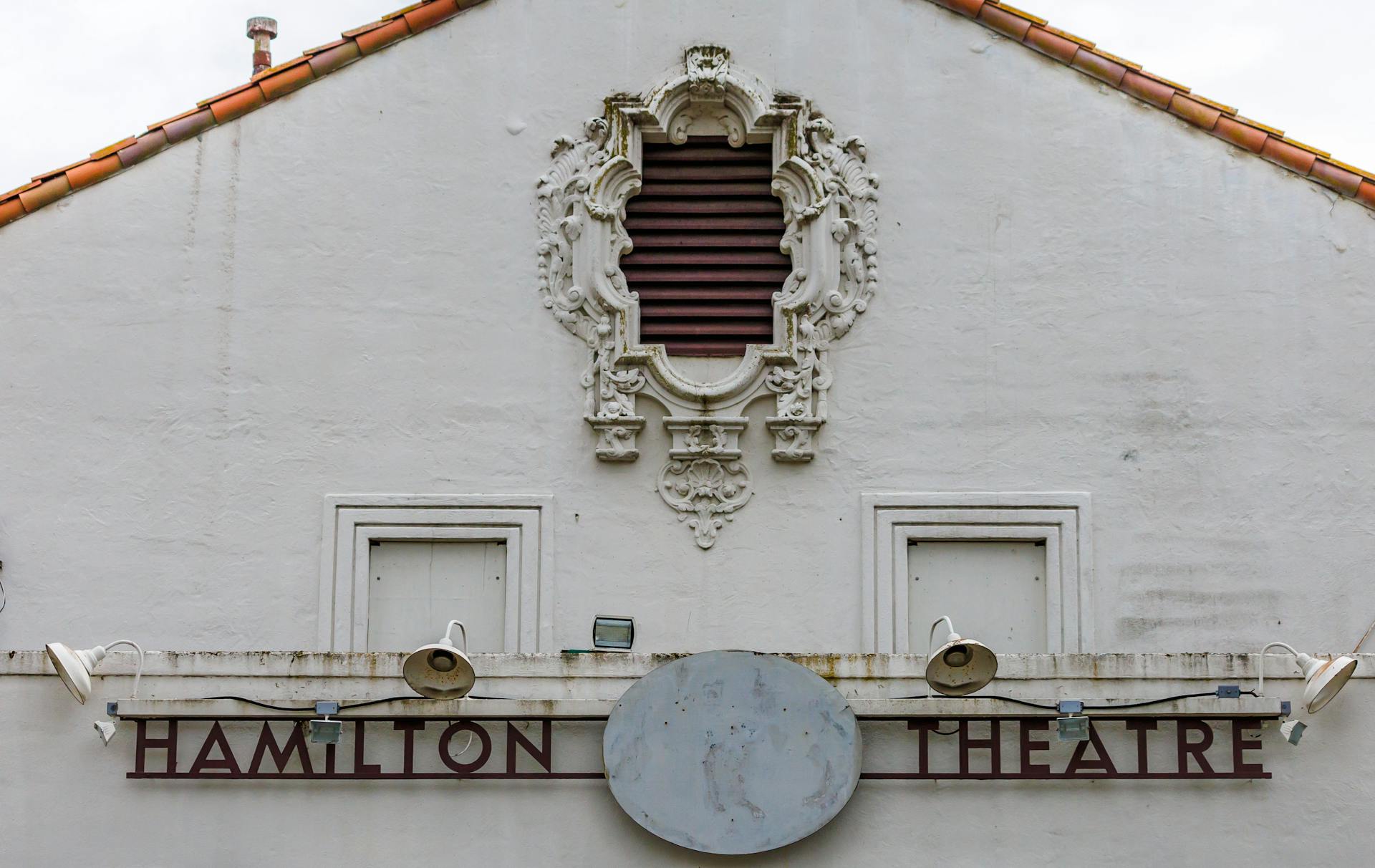 Detailed view of Hamilton Theatre's vintage facade and signage.