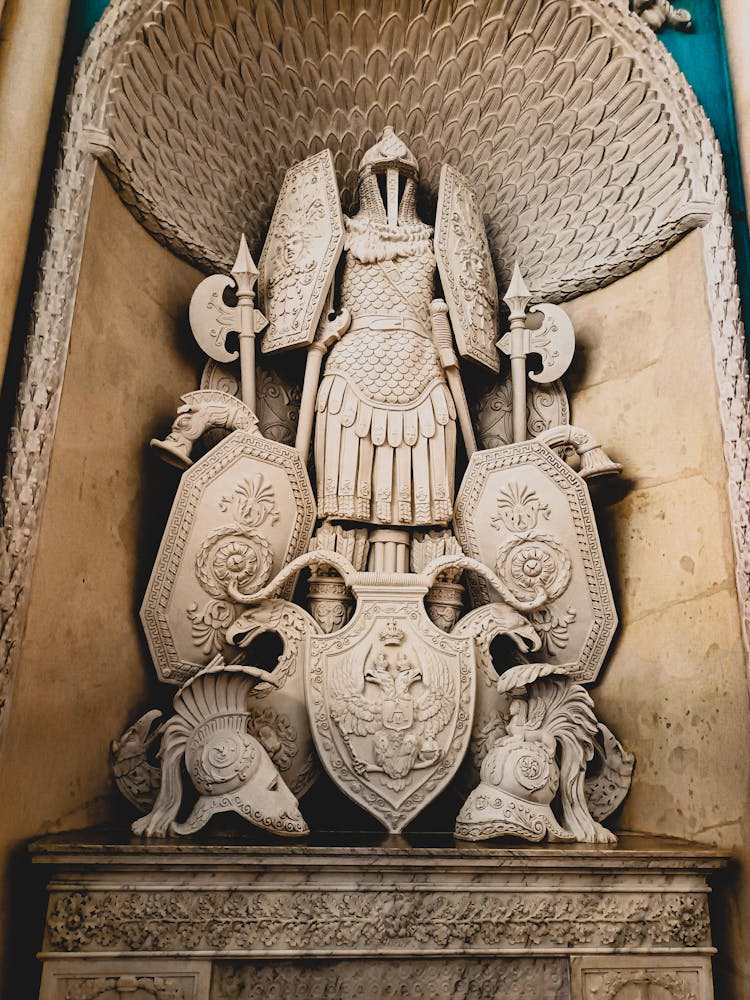 Sculpture Of An Armor Suit, Shield And Axes On Display