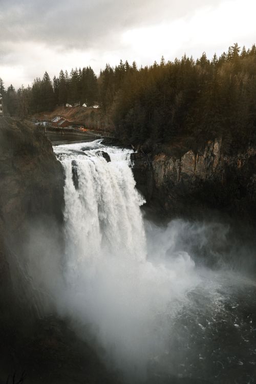 Free Stunning waterfall cascading amid misty forest landscape, perfect for nature enthusiasts. Stock Photo
