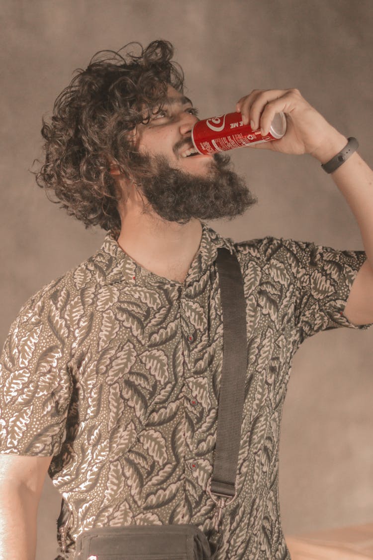 Man In Brown Printed Shirt Drinking Softdrinks